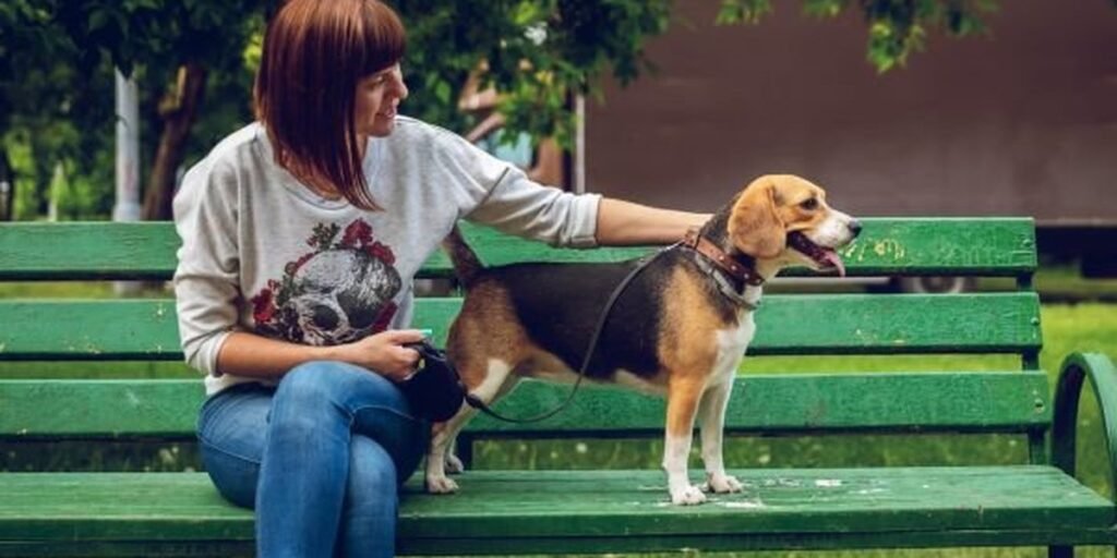 A pet parent relaxing happily with their dog